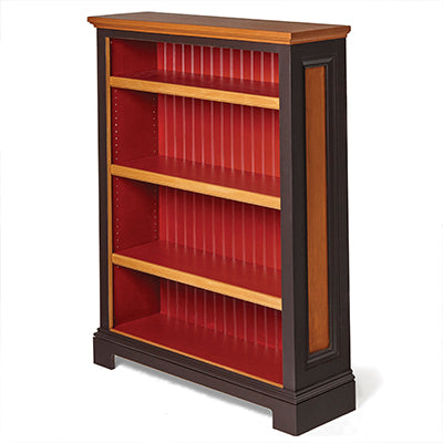 Finished wooden bookcase with red beadboard backing and contrasting stained trim panels