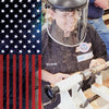 Woodturner wearing face shield shaping pen blanks on lathe with American flag overlay