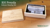 Wooden box with RH Preyda Deluxe Honing Kit including sharpening stones and instructions on a workbench