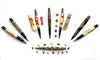 Collection of handcrafted wooden pens with various inlay designs including ribbons, card suits, and geometric patterns