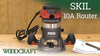 SKIL 10A plunge router on wooden workbench with manual and pen nearby