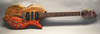 Electric guitar with carved wooden fish-shaped body and detailed wood grain finish