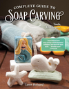 Soap blocks carved into a mermaid, whale, and starfish showcasing soap carving techniques.