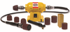 Yellow Guinevere rotary power tool with sanding drum attachments and abrasive sleeves for woodworking finishing tasks.