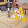 Hand adjusting Microjig FitFinder gauge on router table to set cutter height accurately