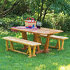 Outdoor wooden picnic table and benches with trestle-style legs on grass under trees